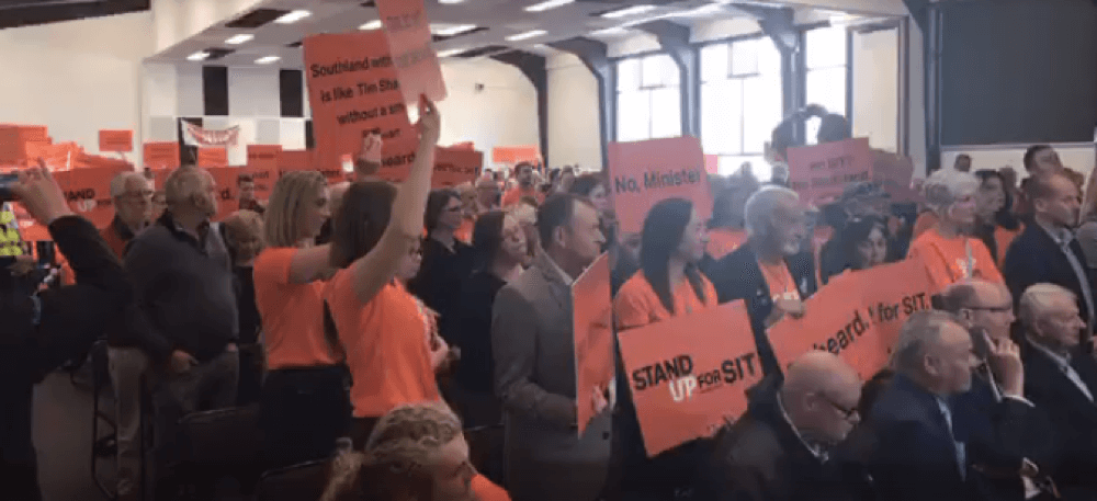 Education Minister Faces Sea of Orange (watch full meeting)