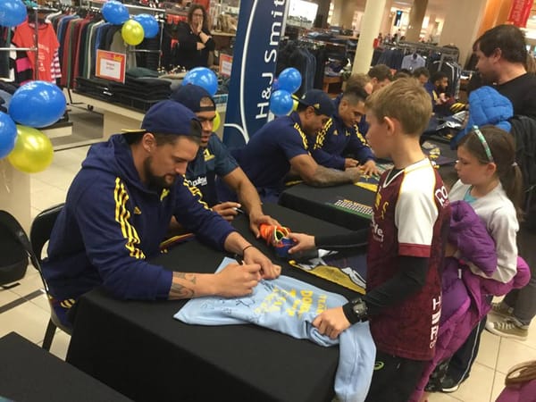 Crowds Lineup To Meet The Highlanders At H&J Smith