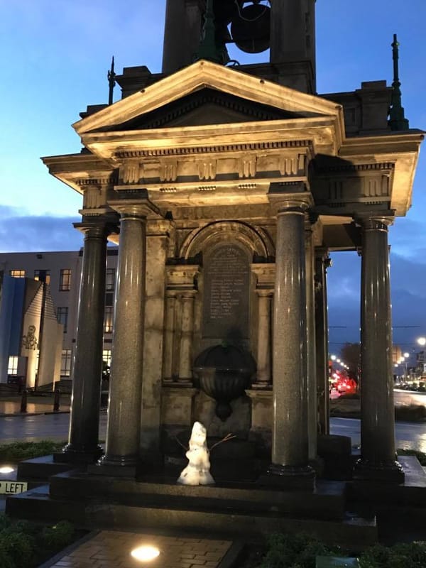 Frosty The Snowman Takes Shelter Under War Memorial